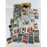 A collection of assorted vintage ephemera to include postcards, chewing gum cards and Brooke Bond