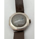 A vintage silver cased Swiss 15 jewels wristwatch with brown leather strap. Steel grey face with