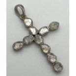 A silver cross shaped pendant set with 10 rough cut diamonds. Each diamond approx. 2mm x 3mm. Each