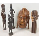 A collection of assorted vintage carved wood ethnic tribal figures and a wall hanging mask. In