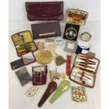 A collection of assorted vintage vanity items to include compact, manicure sets, purses, sewing