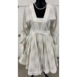A vintage 1960's white cotton polka dot and crochet trim mini dress by Jean Varon - Size 14. Long