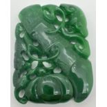 A carved piece of jade in the form of a bamboo stem and a gourd with mixed foliage. Carved detail to