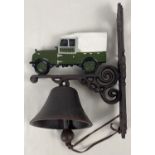 A wall mountable painted cast iron garden bell with painted Land Rover detail and leather strap bell