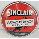 A circular shaped convex enamelled wall sign for Sinclair Pennsylvania Motor Oil. Approx. 29.5cm