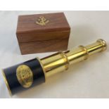 A small brass 3 drawer marine telescope in a wooden box embossed with brass anchor emblem. Box