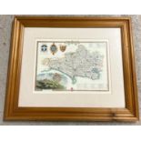 A framed and glazed map of Dorsetshire with printed scene of Shaftesbury and heraldry. In modern