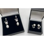 2 pairs of silver pearl set earrings. A pair of pearl drops with twist design and small clear