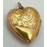 A vintage 9ct gold front and back heart shaped locket with half floral engraved decoration to front.