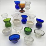 A collection of 17 assorted clear and coloured glass and ceramic eye wash cups. In varying styles,