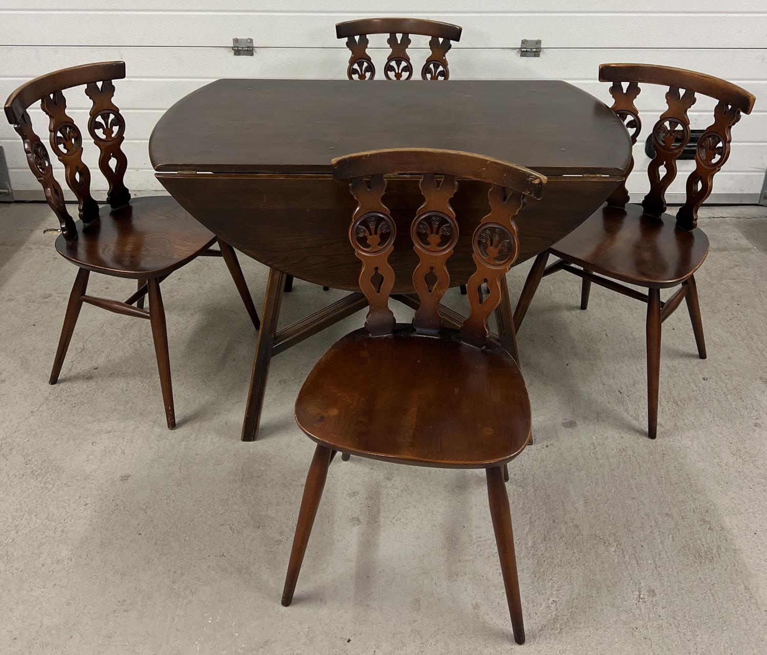 A Mid century Ercol drop leaf dining table together with a set of 4 Ercol dining chairs. Unmarked