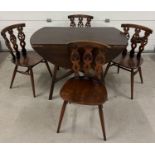 A Mid century Ercol drop leaf dining table together with a set of 4 Ercol dining chairs. Unmarked