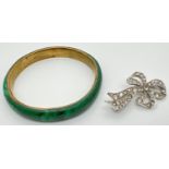 2 items of vintage costume jewellery. A vintage bow brooch set with 50+ round cut clear stones,
