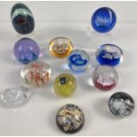 A collection of 12 assorted glass paperweights, to include 5 from Caithness - marked & named to
