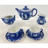 A 19th century Wedgwood Portland blue Jasperware dipped tea for two set. Comprising: lidded