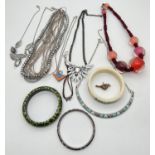 A small collection of costume jewellery necklaces and bangles. To include white metal enamel bangle,