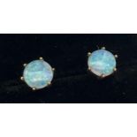 A pair of 9ct gold and opal stud earrings for pierced ears. Single round cut opal stone in a claw