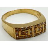 A modern 18ct gold ring with Greek key design mount set with 24 small diamonds. Stamped 750 inside