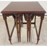 A vintage dark wood nest of 3 tables with 2 small drop leaf folding tables and larger square