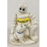 A painted cast iron figure of a Michelin man and his dog. Approx. 20cm tall and weighs 3.1kg.