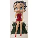 A painted cast iron shelf figure of Betty Boop singing. Approx. 26cm long and weighs 2.75kg.