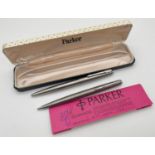 A vintage brushed stainless steel case propelling pencil together with a vintage silver tone cased