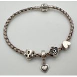 An 8" silver leather plaited charm bracelet by Pandora with 4 charms. Charms comprise: solid
