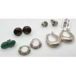 5 pairs of silver and white metal stud and hoop style earrings. To include floral design stud sets