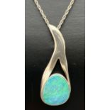 A vintage contemporary design silver pendant necklace set with an opal, on a 20" rope chain. Pendant
