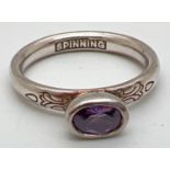 A Danish silver Spinning ring by Hans Henryk Nygaard. With bezel set oval cut amethyst and floral