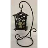 A decorative cast iron, free standing, garden candle lantern and stand. Approx. 47cm tall.