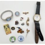 A collection of vintage pin badges together with a men's wristwatch by Rojas and a ladies wristwatch