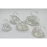 2 marked Swarovski crystal swan figures together with 3 other unmarked crystal swans. In varying