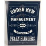 A large modern printed tin Peaky Blinders sign. With holes for wall fixing. Approx. 69.5cm x 50cm.