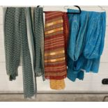 3 decorative Sari's. A green, white and yellow floral design chiffon material sari; a bright blue
