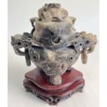 A carved soapstone oriental lidded Koro with wooden stand. Carved dragon head and ring detail to