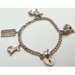 A vintage silver double curb chain charm bracelet with padlock and safety chain and 4 silver & white