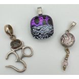 3 stone set pendants. A silver Om pendant set with dendritic quartz; a silver drop pendant set