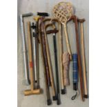 10 walking sticks in various materials, lengths and designs to include carved wood. Together with