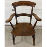 An antique elm wood, bar backed farmhouse kitchen arm chair. With turned detail to legs and arm