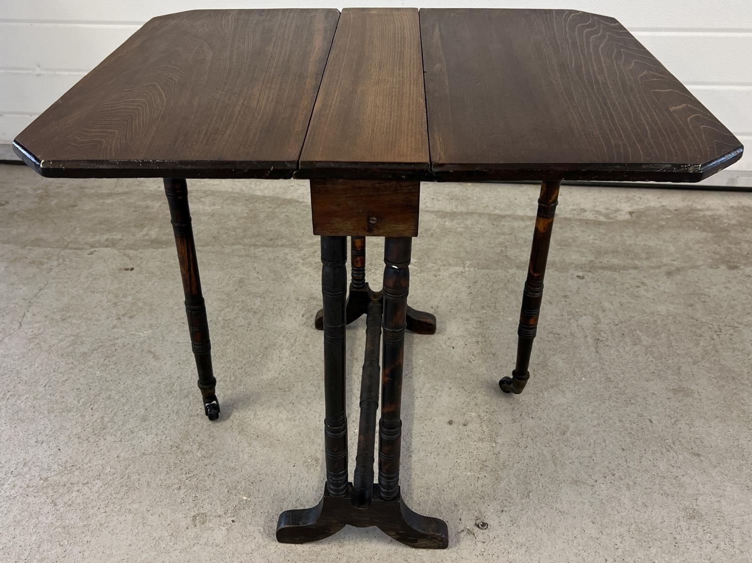 A small antique dark wood Sutherland style drop leaf table with turned detail to legs. Gateleg - Image 2 of 4