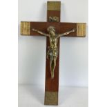 A large vintage wooden wall hanging crucifix with brass plated figure and panels with Latin verse.