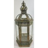 A large modern Eastern style metal and glass panelled hexagonal lantern with hinged door.