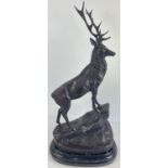 A very large bronze figure of a stag mounted on a black marble base. Approx. 71cm tall x 35cm wide