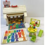 A vintage Fisher Price School House with magnetic alphabet letters and numbers, figures and