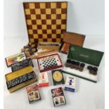 A collection of assorted playing cards, draughts, dominoes and chess games. With a wooden games