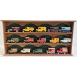 A wooden wall hanging display shelf unit for model cars, together with 15 advertising diecast