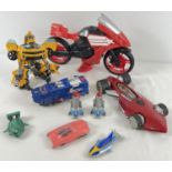 A collection of assorted vintage toy vehicles. To include Transformers, Thunderbirds and Hotwheels