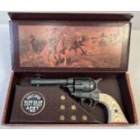 A boxed Replica Single Action Army . 45 revolver toy gun with wood effect grip. Complete with