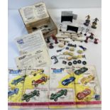 A box of original Tri-ang pit stop figures, fencing, straw bales and other accessories to include